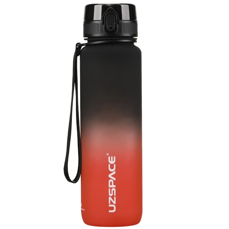 Eine Sporttrinkflasche mit einem Farbverlauf von schwarz zu rot, ausgestattet mit einem Trageband und einem Klappdeckel. Auf der Flasche ist das Markenlogo "UZSPACE" sichtbar.